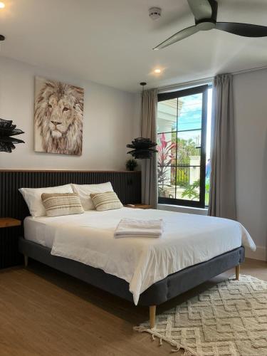 a bedroom with a bed with a lion painting on the wall at Lulu Diani in Diani Beach