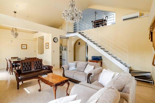 a living room with a couch and a staircase at Anniversario in Onna