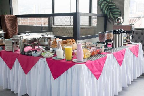 a table with a buffet of food on it at Edificio Helena in Medellín