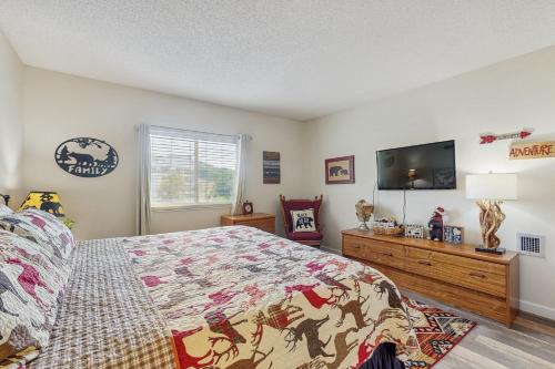 a bedroom with a bed and a flat screen tv at Delightful Condo Sleeps 6 Shared Pool Picnic Area in Pigeon Forge