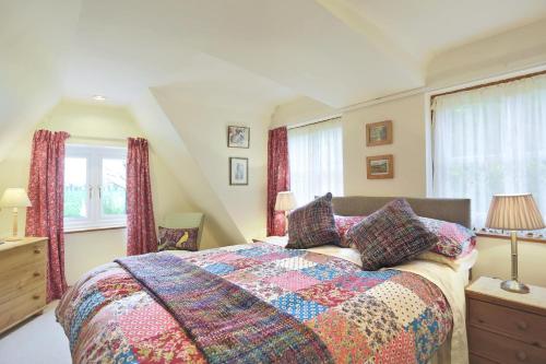 a bedroom with a bed with a colorful quilt at 1 Bed in Frostenden oc-phc in Frostenden
