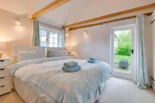 a bedroom with a large bed with towels on it at 1 Bed in Biddenden oc-cb635 in Biddenden