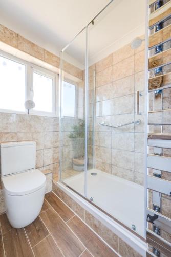 a bathroom with a tub and a toilet and a shower at 2 Bed in Walcott oc-2301 in Walcott