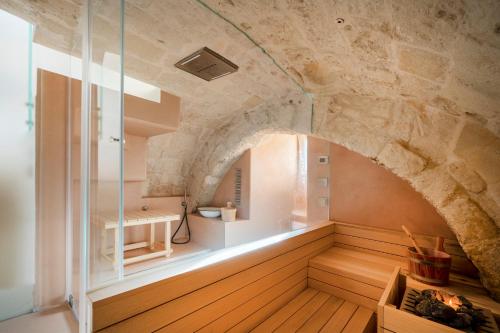 a room with a stone wall and an archway at Suite San Pietro - Sassi di Matera in Matera