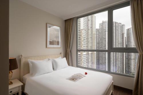 a hotel room with a bed and a large window at SG lusxury city in Ho Chi Minh City