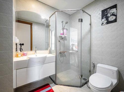 a bathroom with a shower and a toilet and a sink at SG lusxury city in Ho Chi Minh City
