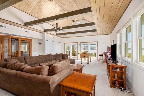 a living room with a couch and a table at Lakeside Getaway with Dock, Firepit, Grill in Newaygo