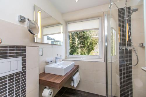 a bathroom with a sink and a shower at Parkhotel Cochem- Free Parking - in Cochem