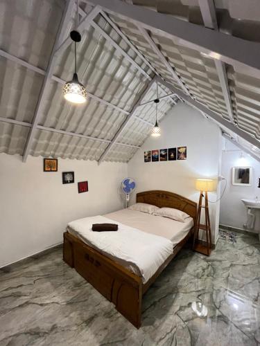 a bedroom with a large bed and a sink at TauSco Homestay & Campsite - Coorg in Madikeri