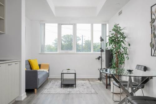 a living room with a table and a couch at Modern 2 Bed Condo in the Junction+Parking in Toronto