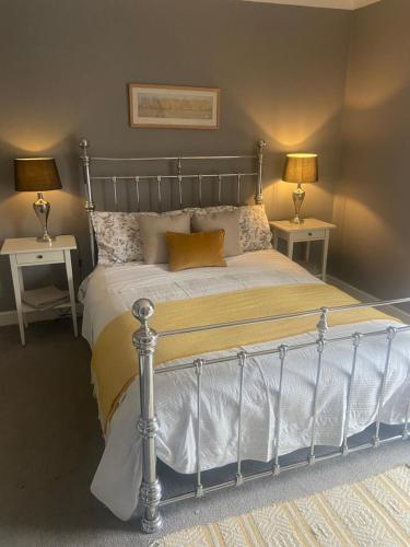 a bedroom with a bed with two lamps on two tables at The City Pad in Norwich