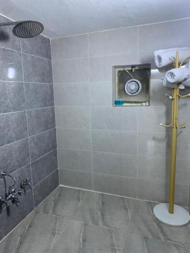 a bathroom with a shower with a toilet and a sink at Danzha Royal 4 in Erbil