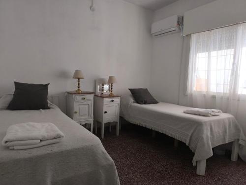 a bedroom with two beds and a window at La casa in Gualeguaychú