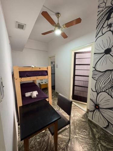 a bedroom with a bunk bed and a ceiling fan at Hotel Parque in Necochea