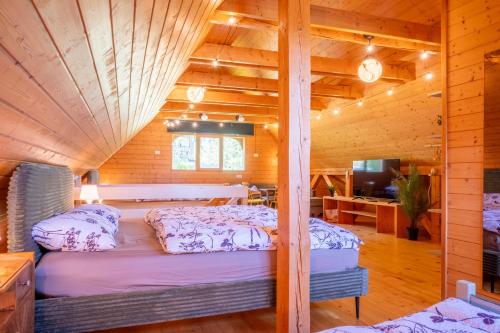 a bedroom with a bed in a wooden cabin at Chalet Guapa in Bohinj