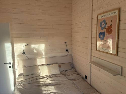 a bedroom with a bed with two lights on the wall at Ferienhaus Barth in Waldbröl in Waldbröl