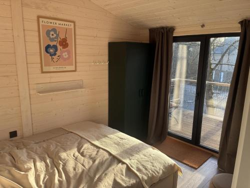 a small bedroom with a bed and a window at Ferienhaus Barth in Waldbröl in Waldbröl