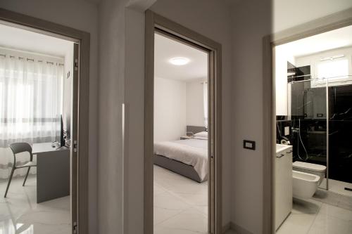 a room with a bedroom and a bed and a bathroom at Loft Giuliana in San Michele allʼAdige