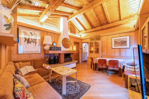 a living room with a couch and a table at Tizzi Home in Alleghe