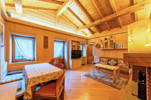 a living room with a table and a dining room at Tizzi Home in Alleghe