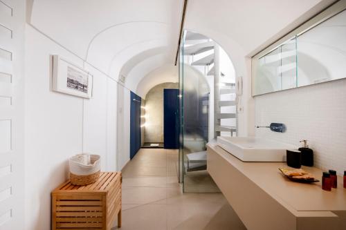 a bathroom with a sink and a mirror at Dimora Delle Stelle - Design & Heritage in Bari