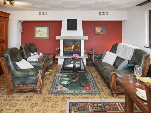 a living room with leather furniture and a fireplace at Chalet Chalet Chante Neige by Interhome in Riddes