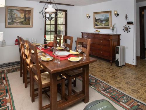 a dining room with a wooden table and chairs at Chalet Chalet Chante Neige by Interhome in Riddes