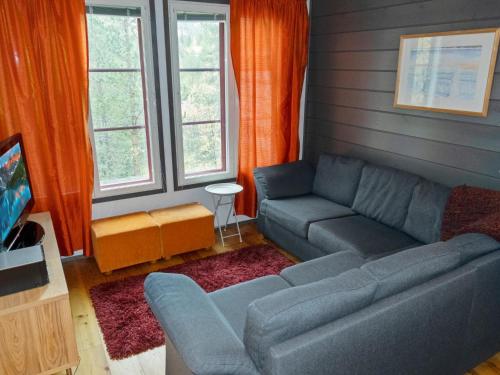a living room with a couch and a tv at Holiday Home Pulkka 2 by Interhome in Salla