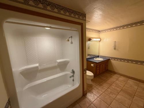 a bathroom with a tub and a toilet and a sink at Angelina Motel in Lufkin