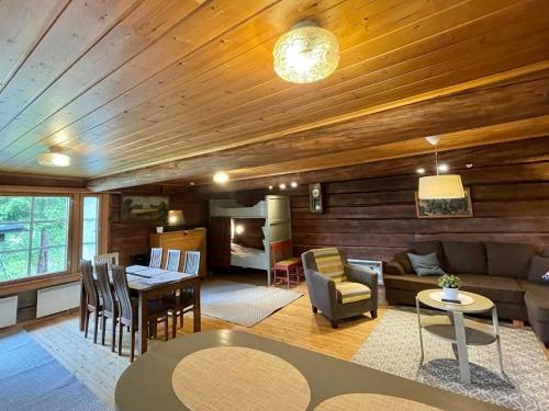a living room with a couch and a table at Holiday Home Metsäpirtti by Interhome in Vaskivesi