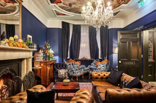 a living room with a couch and a fireplace at The Lawrence in Derry Londonderry