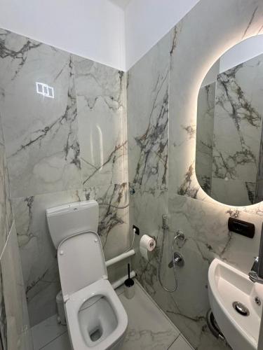 a bathroom with a toilet and a sink and a mirror at Casa Giovanni in Turin