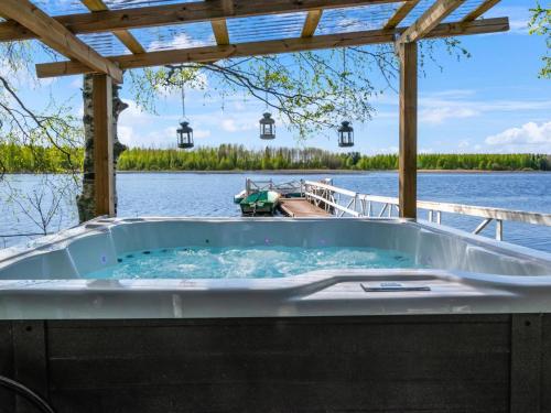 a jacuzzi tub on a boat on a lake at Holiday Home Tuliniemi by Interhome in Iisalmi