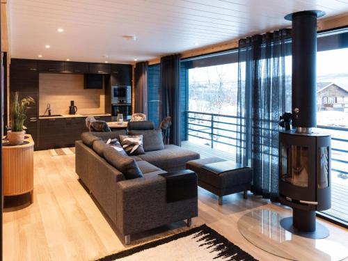 a living room with a couch and a fireplace at Holiday Home Saanan lumous by Interhome in Kilpisjärvi