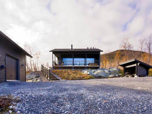 a house on a hill with a building at Holiday Home Saanan lumous by Interhome in Kilpisjärvi