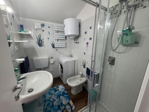 a bathroom with a shower and a sink and a toilet at Attico Vicky in Porto Azzurro