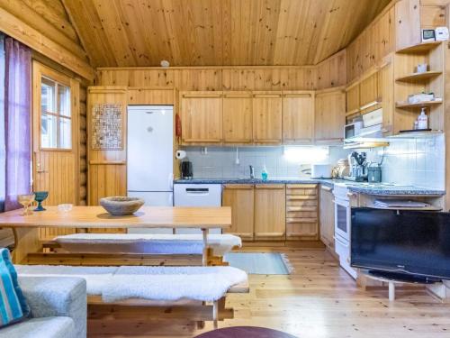 a kitchen with wooden cabinets and a wooden table at Holiday Home Pyhäkolo by Interhome in Pyhätunturi