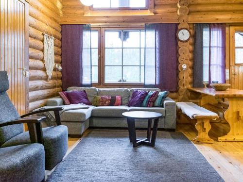 a living room with a couch and a table at Holiday Home Pyhäkolo by Interhome in Pyhätunturi