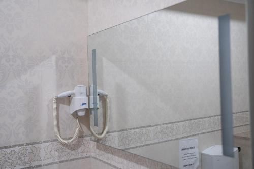 a phone hanging on a wall in a bathroom at Hanul Simonului in Bran