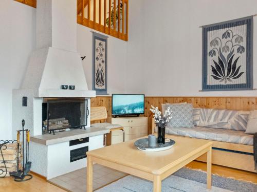 a living room with a couch and a table at Holiday Home Siulapalkinen a 4 by Interhome in Saariselka