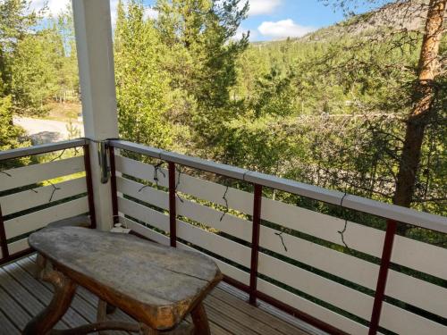 a wooden bench sitting on a porch with a view at Holiday Home Kelkka 1 by Interhome in Salla