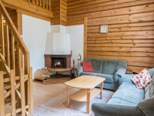 a living room with a couch and a fireplace at Holiday Home Kranni 2 by Interhome in Syöte