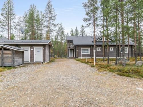 a home with a garage and a house at Holiday Home Otsonherra by Interhome in Pyhätunturi