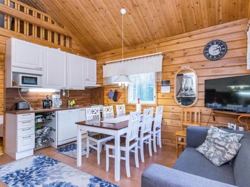 a kitchen and dining room with a table and chairs at Holiday Home Pyhä-vuonelo by Interhome in Pyhätunturi