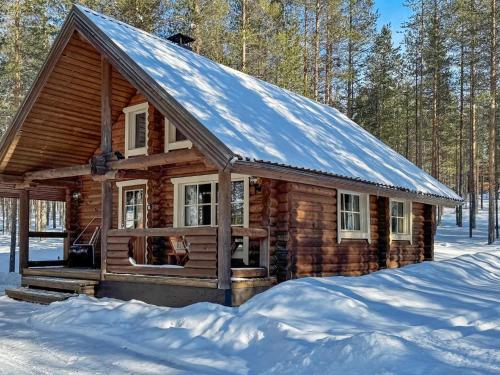 a log cabin in the snow in the woods at Holiday Home Lumomarja by Interhome in Pyhätunturi