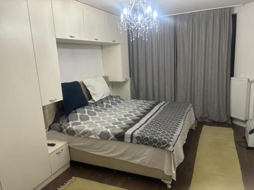 a bedroom with a bed and a chandelier at Apartmen Emina in SJJ
