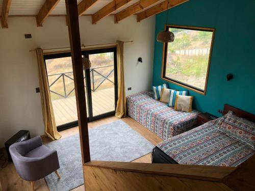 a living room with a couch and a window at Cabañas Don Lino in Cochrane