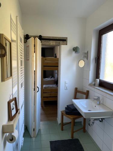 a white bathroom with a sink and a closet at Gastwerk Waldfrieden in Gießen