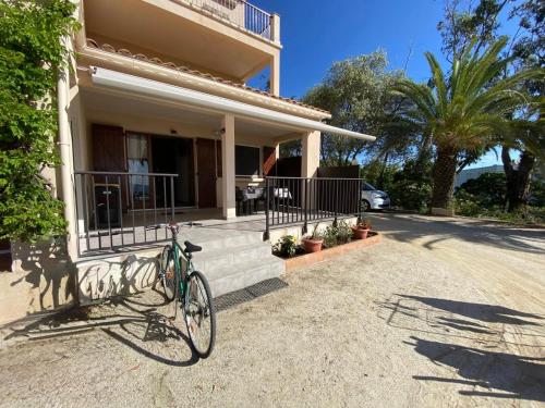 a bike parked in front of a house at Cardellini 4 in Sari Solenzara