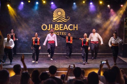a group of people on a stage with a crowd at Oji Beach Hotel in Hacılar